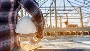 construction worker carrying hardhat