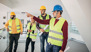 Group of contractors talking on construction site