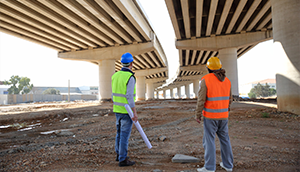 Contractors looking at overpass construction